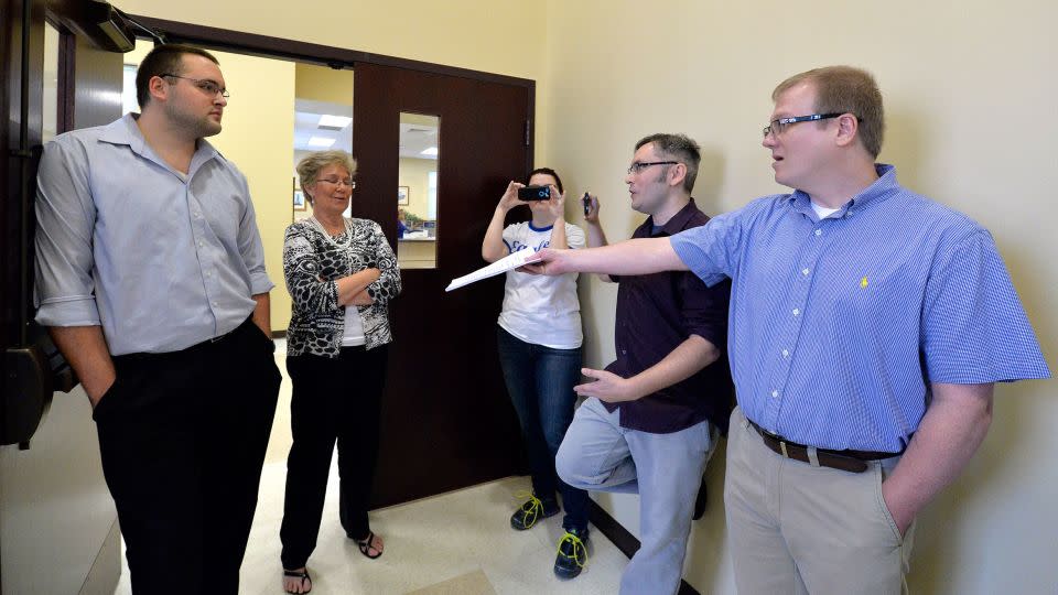 In 2015, David Ermold, right, attempts to hand Rowan County clerks a copy of the ruling from U.S. District Court Judge David Bunning instructing the county to start issuing marriage licenses. - Timothy D. Easley/AP/File