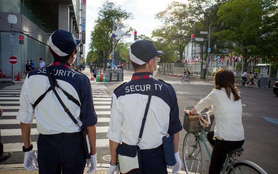 Security officers on patrol in Japan amid a Covid surge - Kentaro Takahashi/Bloomberg