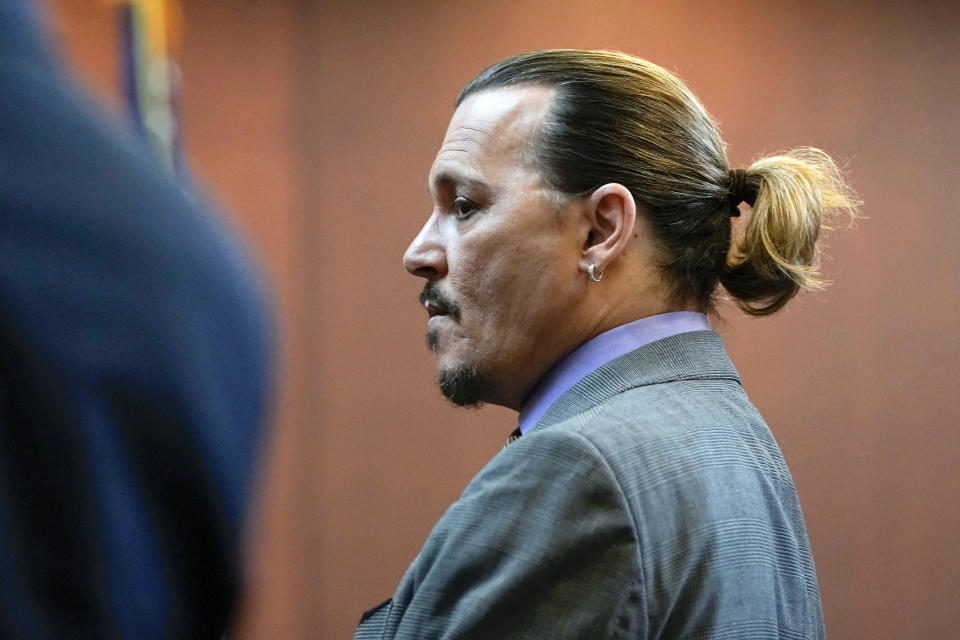 Actor Johnny Depp stands in the courtroom at the Fairfax County Circuit Court in Fairfax, Va., Wednesday May 4, 2022. Depp sued his ex-wife Amber Heard for libel in Fairfax County Circuit Court after she wrote an op-ed piece in The Washington Post in 2018 referring to herself as a "public figure representing domestic abuse." (Elizabeth Frantz/Pool Photo via AP)