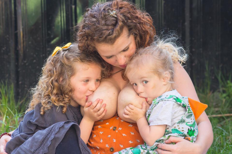 Emma breastfeeds her daughter Alex, five, and son Ollie, two. Photo: Kennedy News