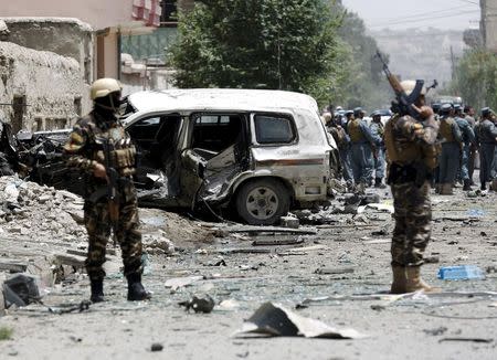 Afghan security forces stand at the site of a suicide attack in Kabul, Afghanistan July 7, 2015. REUTERS/Ahmad Masood