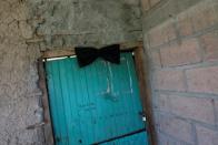 A black ribbon is seen at the door frame of the house of late Honduran migrant Herrera in El Limon