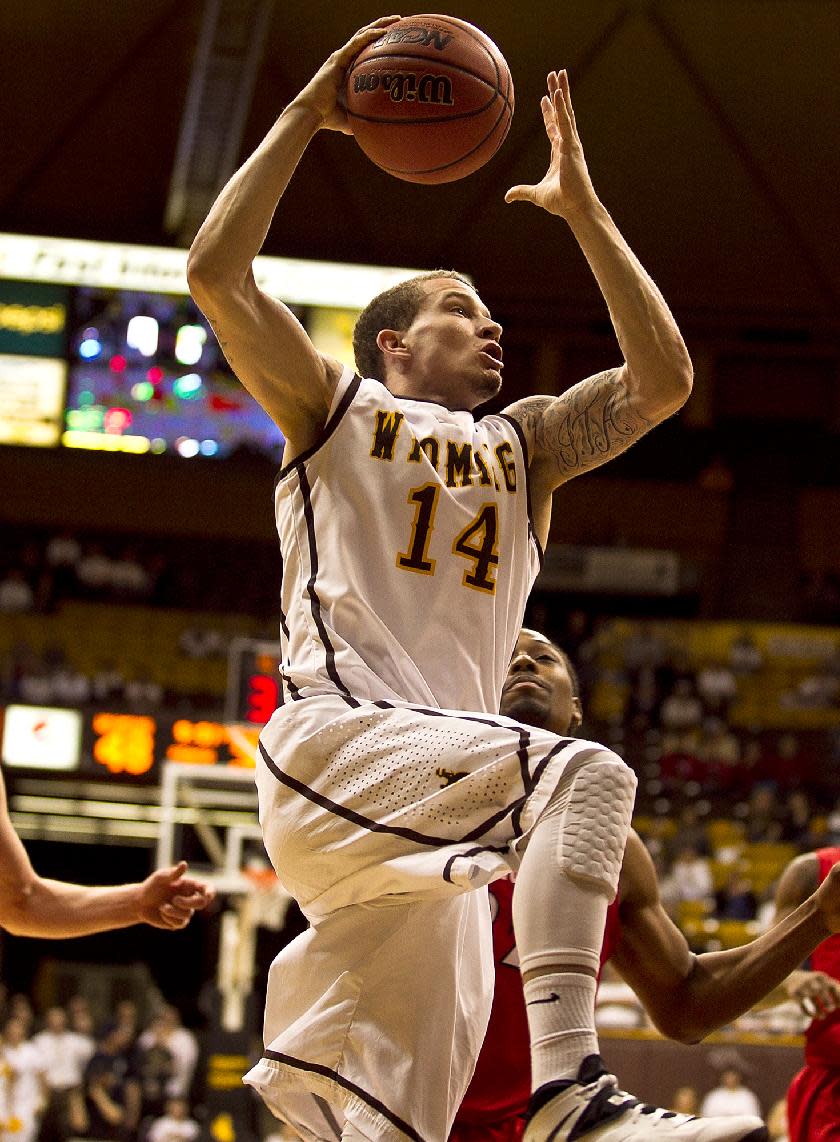 University of Wyoming guard Josh Adams (14) carries the ball up to the net Tuesday, Feb. 11, 2014 against San Diego State at the Arena-Auditorium in Laramie, Wyo. (AP Photo/Jeremy Martin)