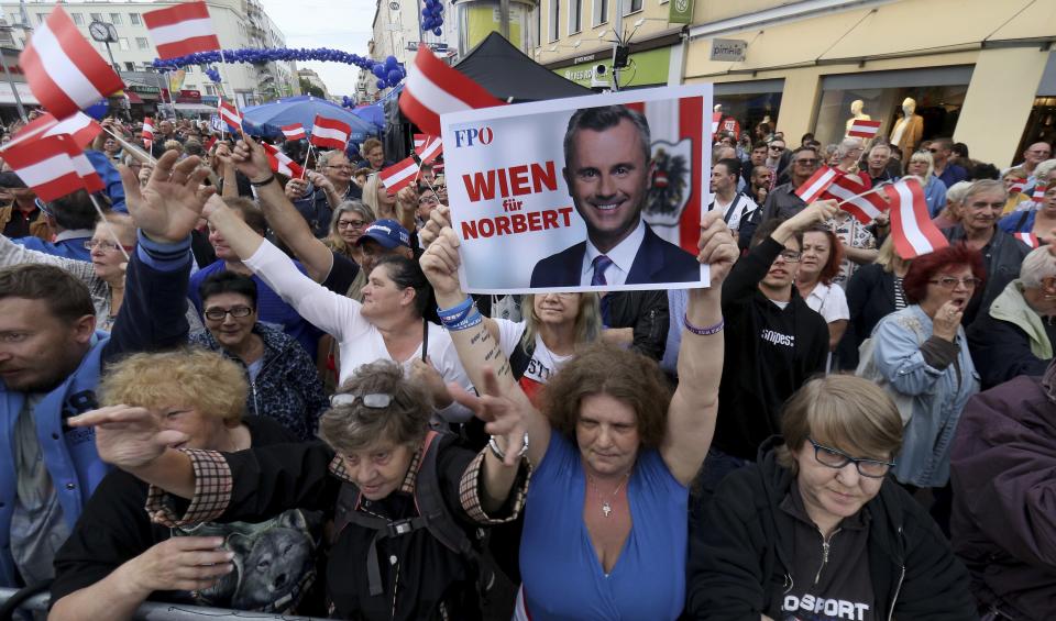 Supporters wave with a poster of Norbert Hofer leader of the right-wing Freedom Party, FPOE, slogan reads: 'Vienna for Hofer' at a closing rally ahead of elections in Vienna, Austria, Thursday, Sept. 27, 2019. The Austrian elections will held on Sunday, Sept. 29, 2019. (AP Photo/Ronald Zak)