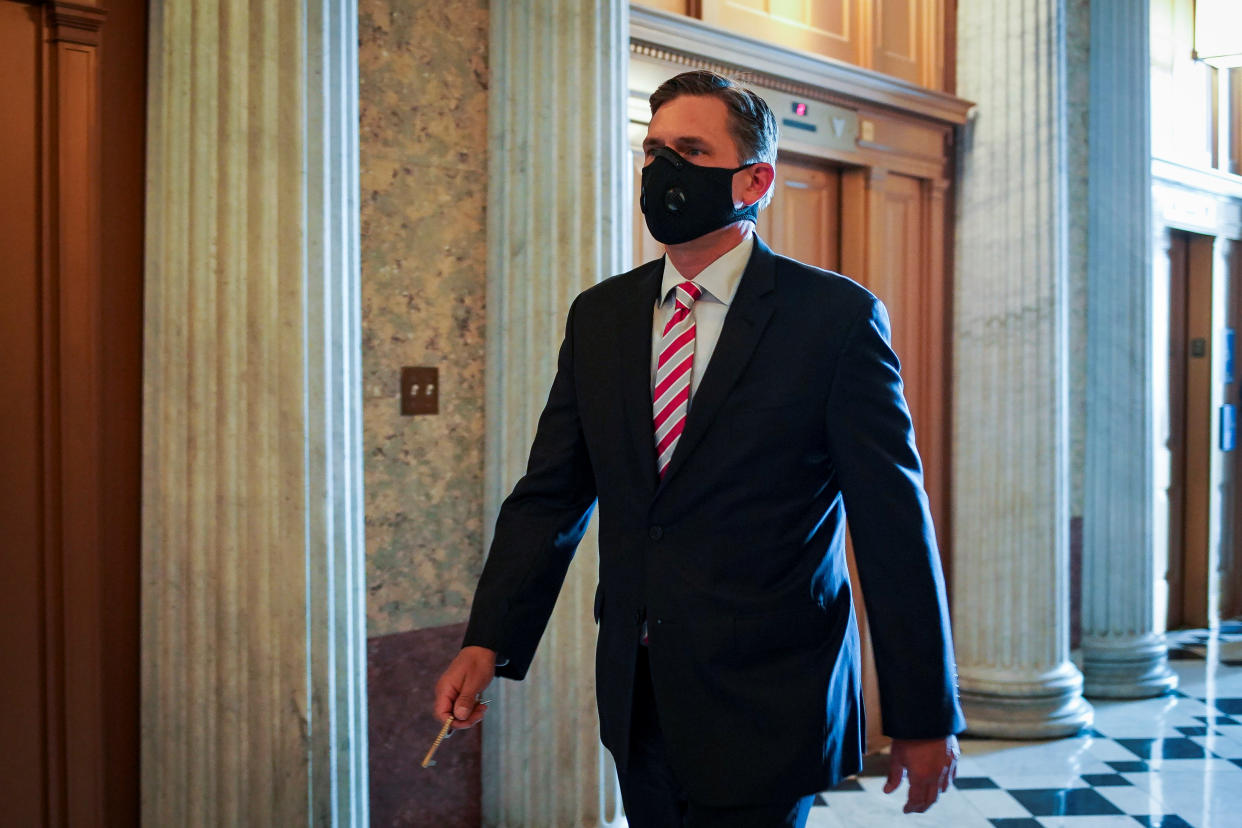 Sen. Martin Heinrich wears a black face mask in hallway in the U.S. Capitol