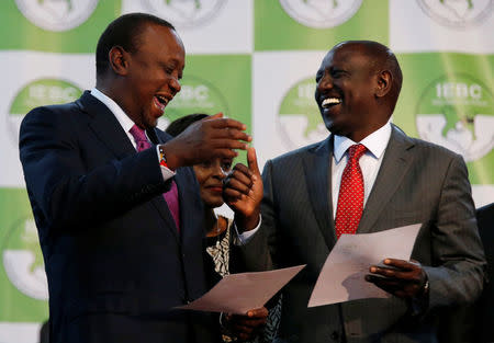 Incumbent President Uhuru Kenyatta celebrates with Deputy President William Ruto after he was announced winner of the presidential election at the IEBC National Tallying centre at the Bomas of Kenya, in Nairobi, Kenya August 11, 2017. REUTERS/Thomas Mukoya