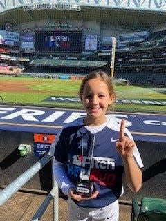 Taylor Holmes, 9, of Allendale with her fist-place trophy at Minute Maid Park in Houston Nov. 4.