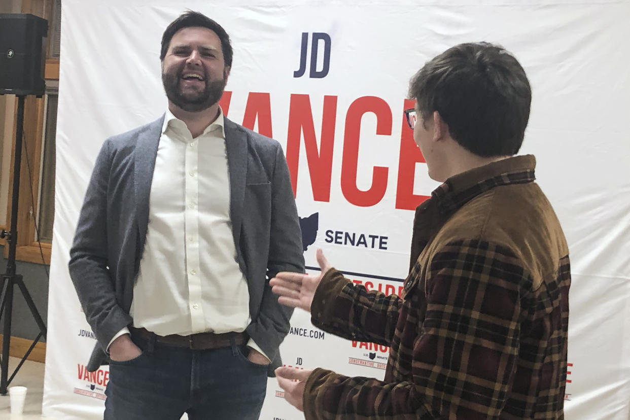Ohio Republican Senate candidate J.D. Vance laughs while speaking with Spencer Johnson at a campaign event in East Canton, Ohio, on March 9, 2022. (AP Photo/Jill Colvin)