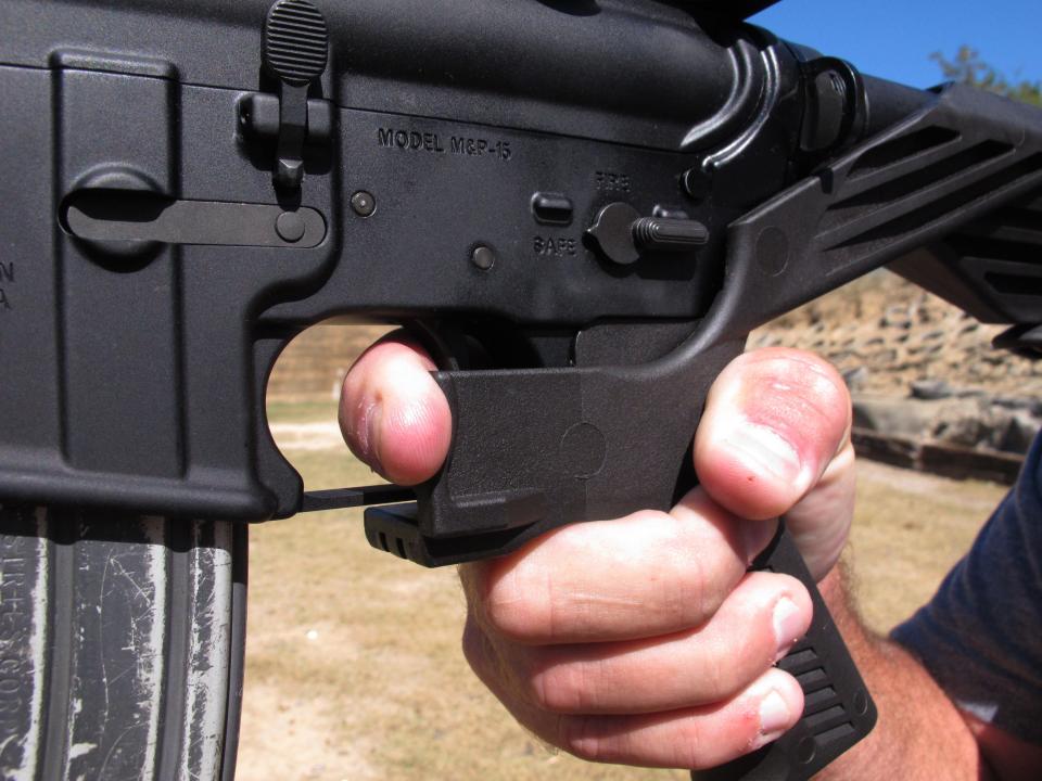 In this Oct. 4, 2017, file photo, shooting instructor Frankie McRae demonstrates the grip on an AR-15 rifle fitted with a "bump stock" at his 37 PSR Gun Club in Bunnlevel, N.C. The devices were used by Stephen Paddock when he opened fire on a country music festival in Las Vegas, killing dozens of people.