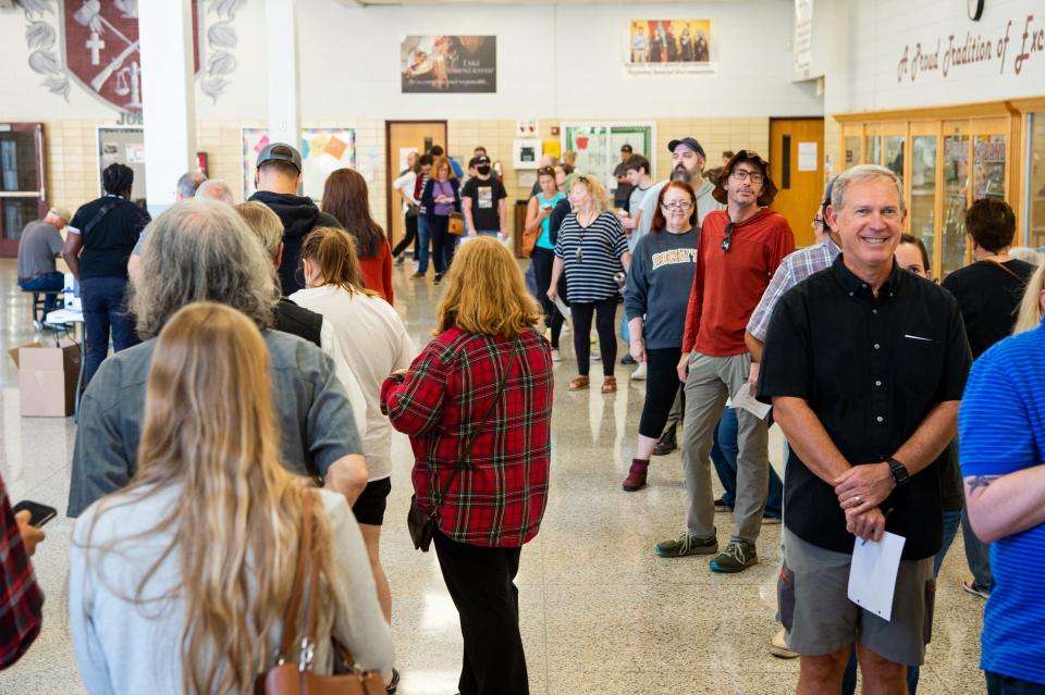 Voters stand in line to cast their ballot at the Bearden High School.