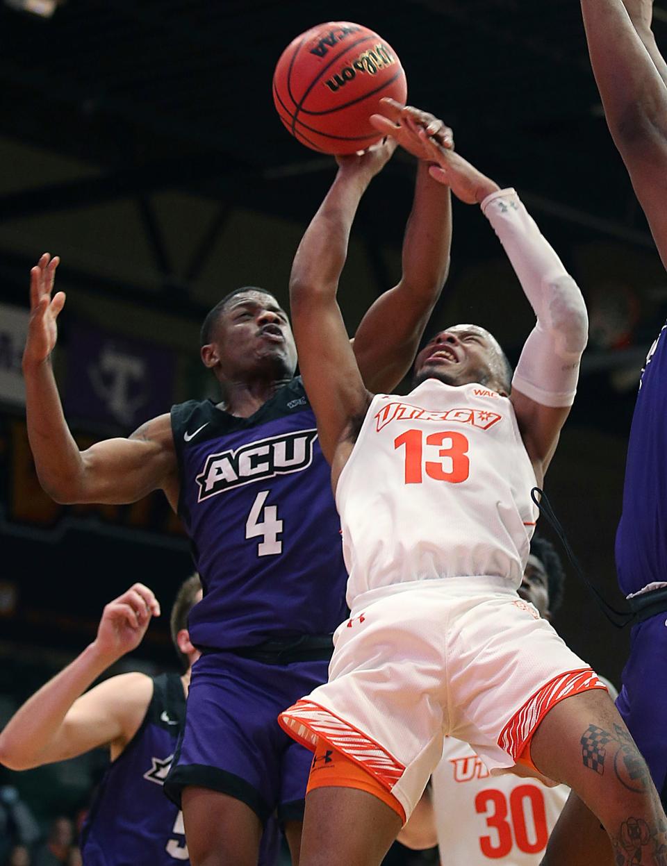 Texas-Rio Grande Valley's Xavier Johnson (13) gets stripped of the ball by Abilene Christian's Damien Daniels (4) during the Western Athletic Conference game Wednesday in Edinburg.