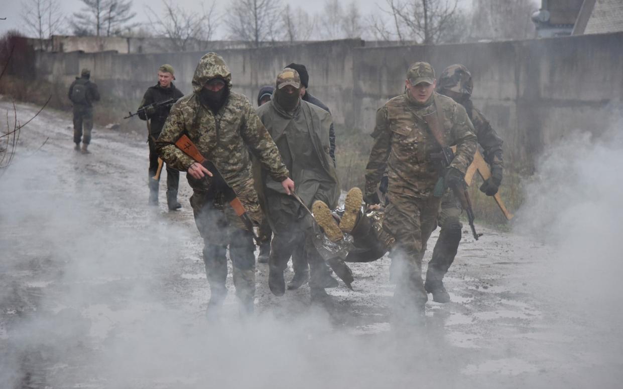 People take part in a military training for civilians in Lviv Region, - Getty