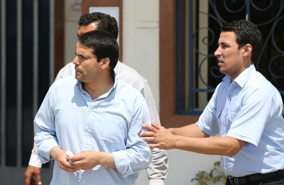 Unidentified relatives and friends of passengers who were flying in an EgyptAir plane that vanished from radar en route from Paris to Cairo react as they wait outside the EgyptAir in-flight service building where relatives are being held, at Cairo International Airport, Egypt, May 19, 2016. (Reuters/Mohamed Abd El Ghany)