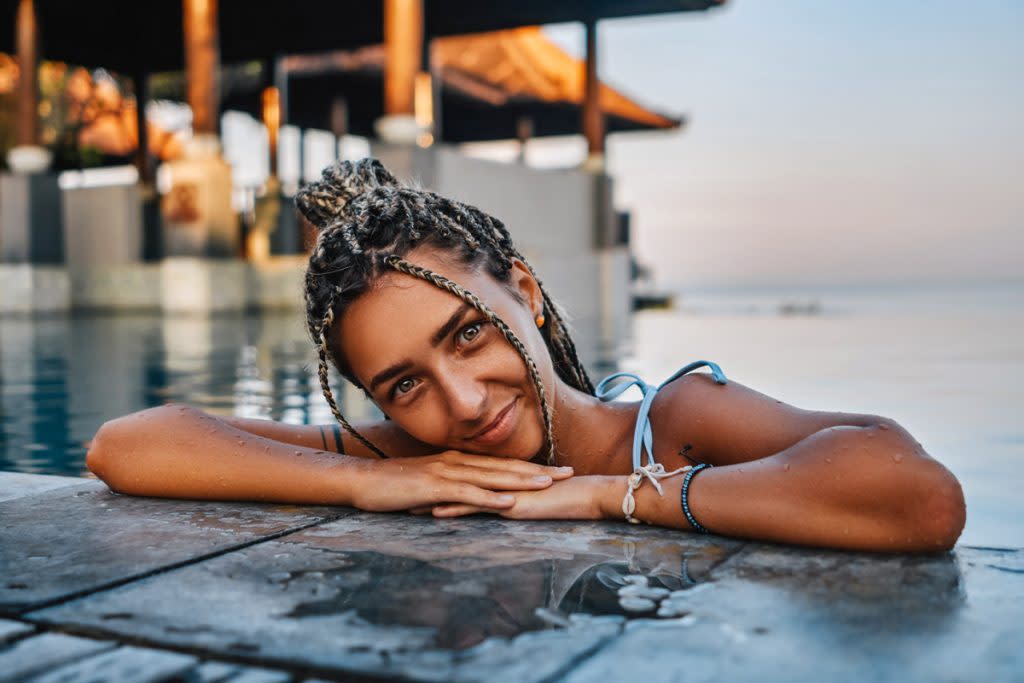 A woman lounges in the water.