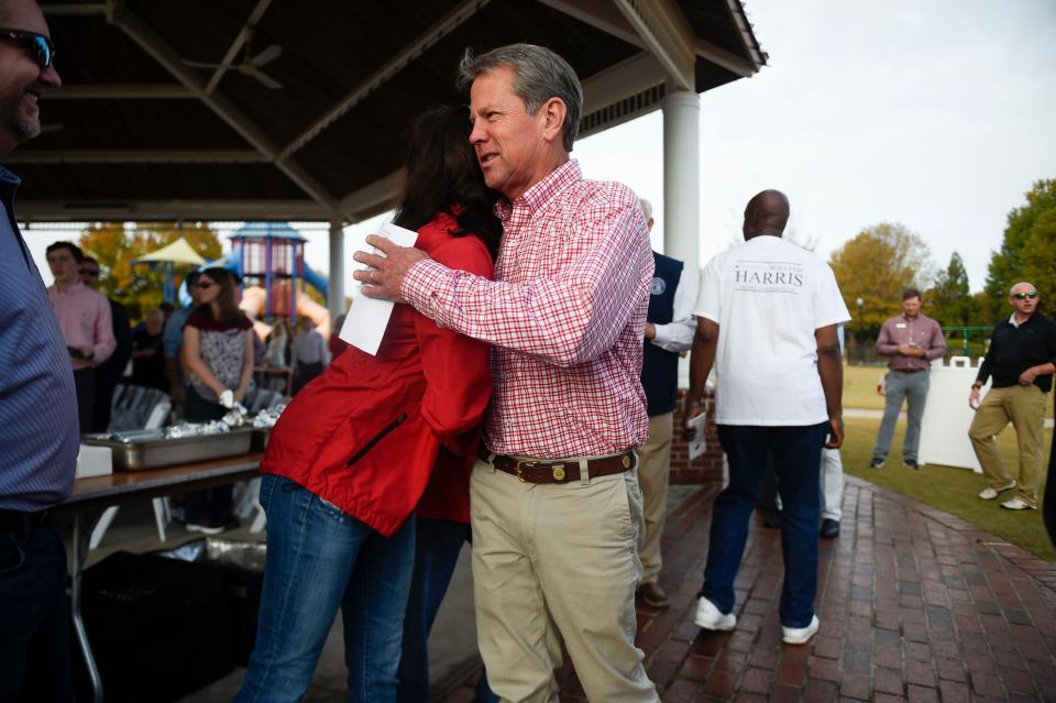Georgia Governor Brian Kemp greets supporters at a campaign stop in Evans Towne Center Park on Saturday, Nov. 5, 2022. Kemp met with voters and encouraged people to turn out to the polls next week. 