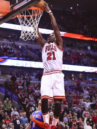 Chicago Bulls guard Jimmy Butler (21) dunks the ball against the New York Knicks during the second half at United Center. The Chicago Bulls defeat the New York Knicks 103-97. Mandatory Credit: Mike DiNovo-USA TODAY Sports