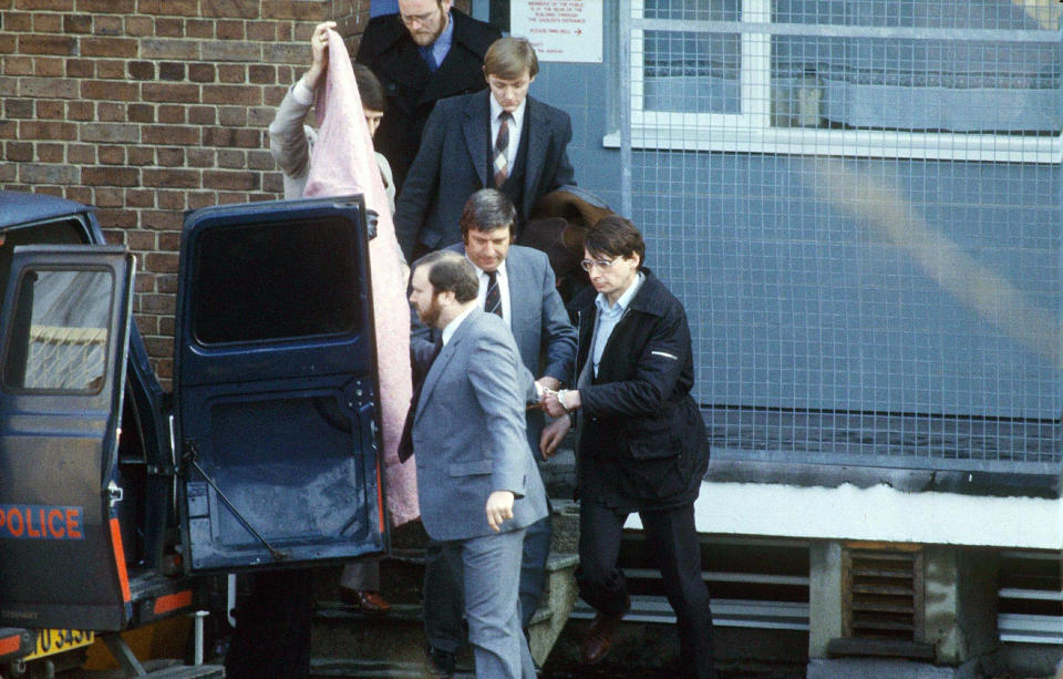 Scottish serial killer, Dennis Nilsen (right), is escorted from Highgate police station to a police van on his way to a court appearance in London, shortly after his arrest in February 1983. Nilsen murdered between 12 and 15 young men between 1978 and 1983. (Photo by Bryn Colton/Getty Images)