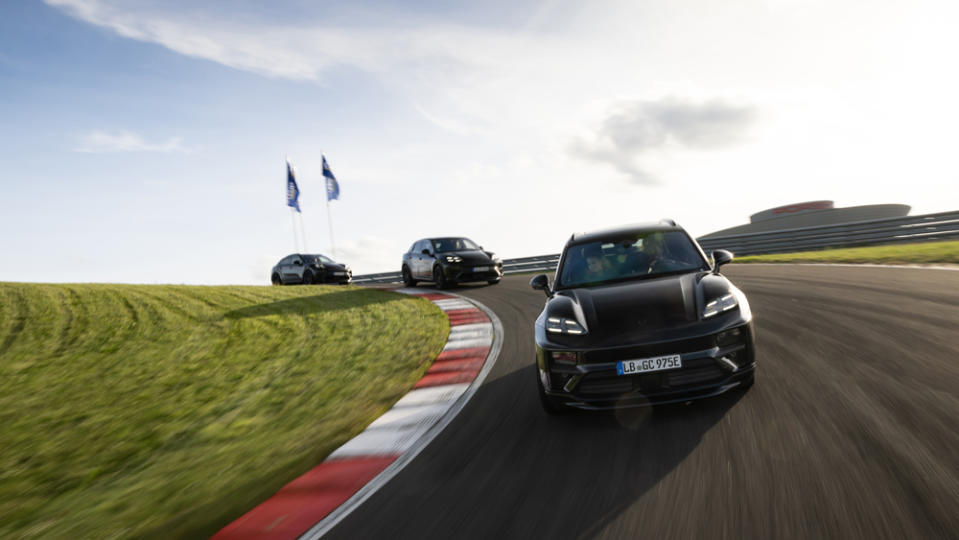 Three examples of the all-electric 2024 Porsche Macan on a racetrack.