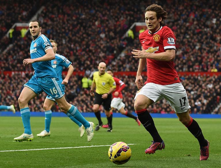 Manchester United's Daley Blind (R) runs with the ball during their English Premier League match against Sunderland, at Old Trafford in Manchester, north-west England, on February 28, 2015