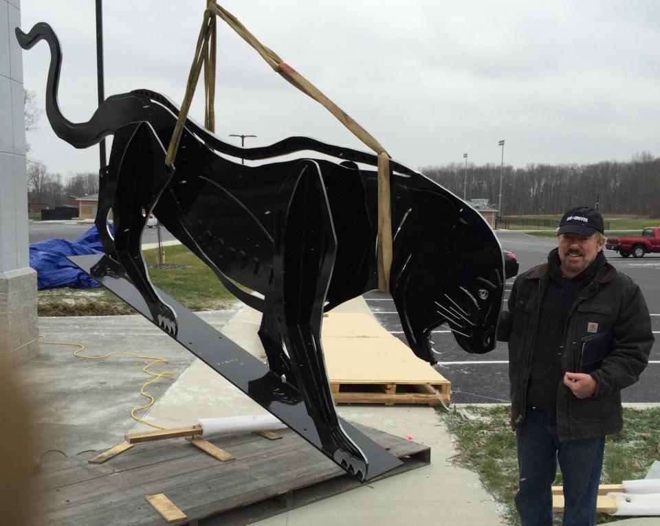 Norton artist Virgil Villers oversees the installation of the "Prowling Panther" sculpture at the new Norton High School in an undated photo.