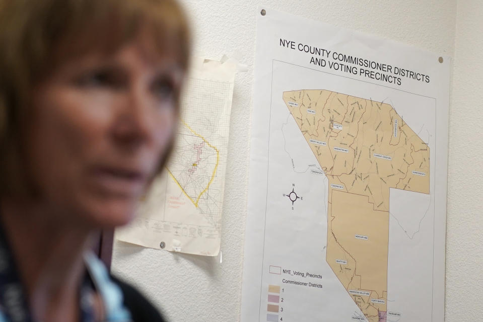 A map of Nye County commissioner districts and voting precincts hangs in the office of Nye County Clerk Sam Merlino, Monday, July 18, 2022, in Tonopah, Nev. Merlino is stepping down from the position, leaving the administration of elections in a county the size of New Hampshire to a new clerk. (AP Photo/John Locher)