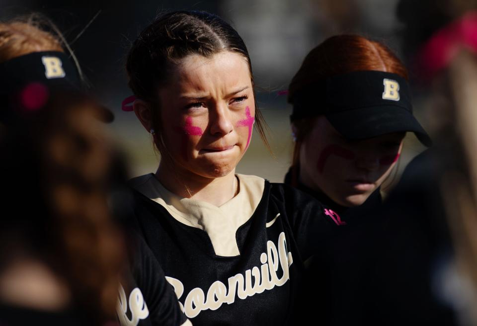 Peyton Pryor and her teammates gather before the start of their home opener against North at Mike Wilson Field Tuesday evening, March 28, 2023. Ashton Pryor, Peyton's older sister, was killed in a one-vehicle accident on the way to school in February and the team all wore her #12 to honor her. 