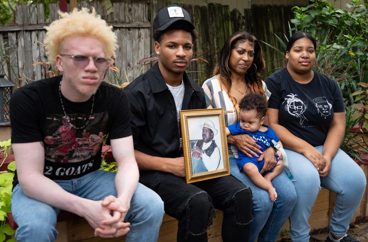 From left, Isaiah Cason-Yett, Nathaniel Bonner Yett, Bonnie Yett, little Sire Yett Thornton and Mia Yett display a photo of Dwight Yett. The family lost Dwight to a stroke in October, four months after a daughter also died from a stroke.