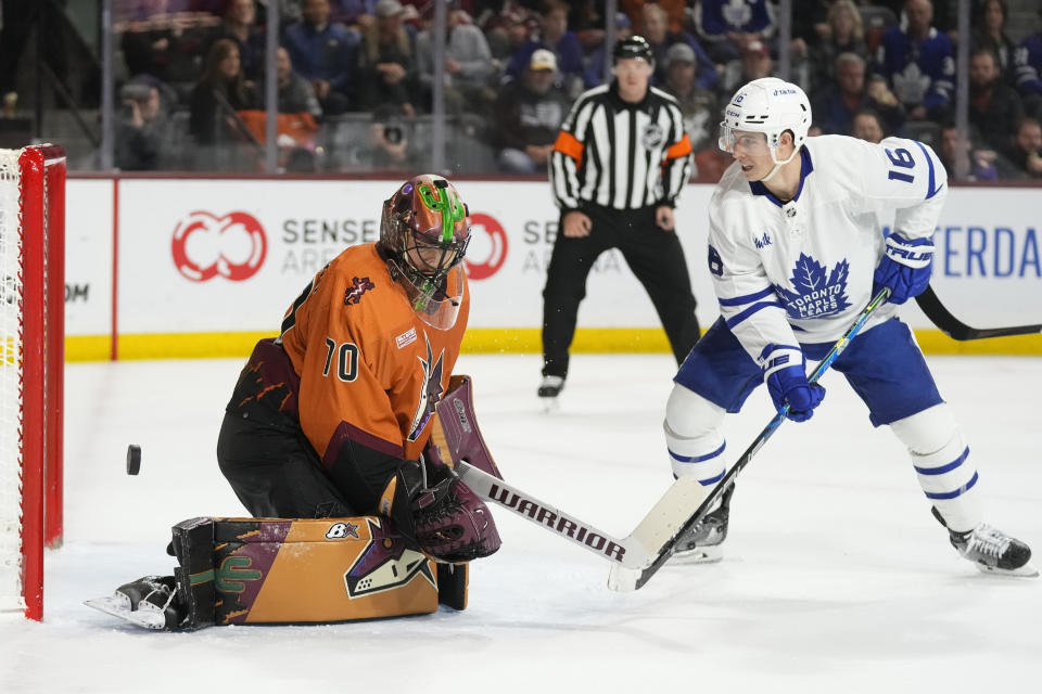 Toronto Maple Leafs right wing Mitchell Marner (16) has his shot go off the pipe as Arizona Coyotes goaltender Karel Vejmelka (70) looks for it during the second period of an NHL hockey game in Tempe, Ariz., Thursday, Dec. 29, 2022. (AP Photo/Ross D. Franklin)