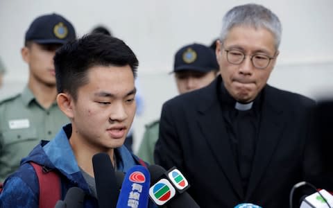 Chan Tong-kai, left, talks to the media as he is released from prison in Hong Kong - Credit: AP