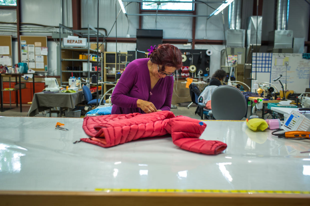 An employee works on a jacket at The Renewal Workshop.