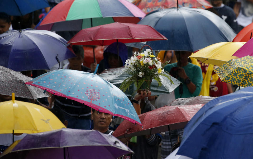 <p>Filipinos troop to Manila’s North Cemetery to visit the graves of their loved ones in the traditional observance of All Saints’ Day, the honoring of the dead among Catholics all over the world Wednesday, Nov. 1, 2017 in Manila, Philippines. Filipinos go to cemeteries and memorial parks on Nov. 1 to honor and pray for the dearly departed. (Photo: Bullit Marquez/AP) </p>