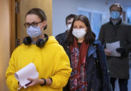 Lithuanian's, wearing face masks to protect against coronavirus, queue to cast their ballots at a polling station during early voting in the second round of a parliamentary election in Vilnius, Lithuania, Thursday, Oct. 22, 2020. Lithuanians will vote in the second round of a parliamentary election on upcoming Sunday during the rise in the incidence of coronavirus infection in the country. (AP Photo / Mindaugas Kulbis)