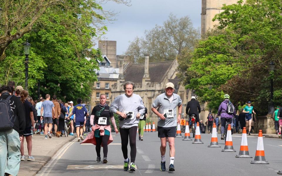 People of all ages run the mile from Christ Church Oxford to the Iffley Road track where Bannister made history