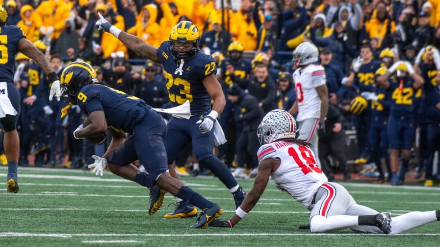 Rod Moore, left, makes a game-sealing interception in the fourth quarter, giving Michigan a 30-24 win over Ohio State. (Getty Images)