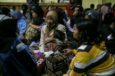 Villagers living near Mount Merapi volcano take shelter in a village hall following a series of minor eruptions in Cangkringan, Sleman, Yogyakarta, Indonesia May 21, 2018 in this photo taken by Antara Foto.  Antara Foto/ Hendra Nurdiyansyah/ via REUTERS