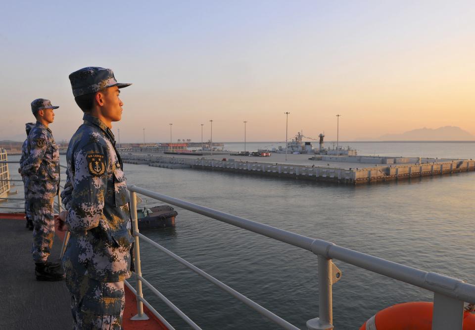 Chinese naval soldiers stand guard on China's first aircraft carrier Liaoning, as it travels towards a military base in Sanya, Hainan province, in this undated picture made available on November 30, 2013. China's sole aircraft carrier left the northern city of Qingdao on Tuesday accompanied by two destroyers and two frigates, the Chinese navy said on an official news website. Ongoing tensions with the Philippines, Japan and other neighbours over disputed territories in East and South China Sea were heightened by China establishing a new airspace defense zone. REUTERS/Stringer (CHINA - Tags: MARITIME MILITARY POLITICS) CHINA OUT. NO COMMERCIAL OR EDITORIAL SALES IN CHINA