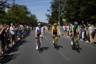 Denmark's Jonas Vingegaard, wearing the overall leader's yellow jersey and who also has the best climber's dotted jersey, Belgium's Wout van Aert of Belgium, wearing the best sprtinters green jersey, and Slovenia's Tadej Pogacar, wearing the best young rider's white jersey, ride during the twenty-first stage of the Tour de France cycling race over 116 kilometers (72 miles) with start in Paris la Defense Arena and finish on the Champs Elysees in Paris, France, Sunday, July 24, 2022. (AP Photo/Thibault Camus)