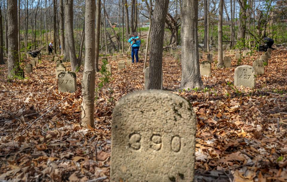 A numbered headstone at the State Farm Cemetery Annex grounds in Cranston. Students at the nearby Rhode Island Training School are not only helping clean up the cemetery, they are researching the histories of those buried there anonymously.