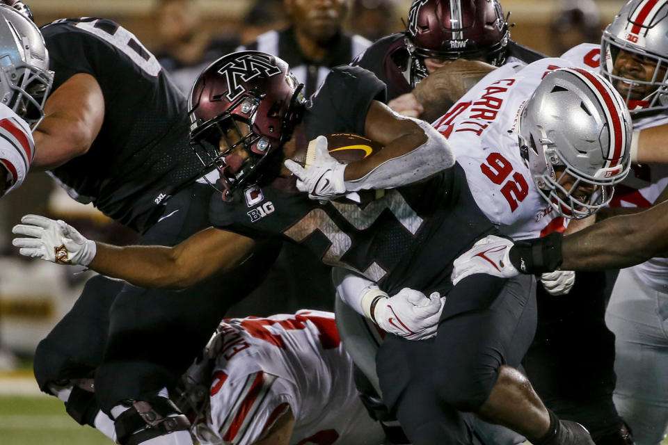 Minnesota running back Mohamed Ibrahim (24) rushes past Ohio State linebacker Haskell Garrett (92) during the second half of an NCAA college football game Thursday, Sept. 2, 2021, in Minneapolis. Ohio State won 45-31. (AP Photo/Bruce Kluckhohn)