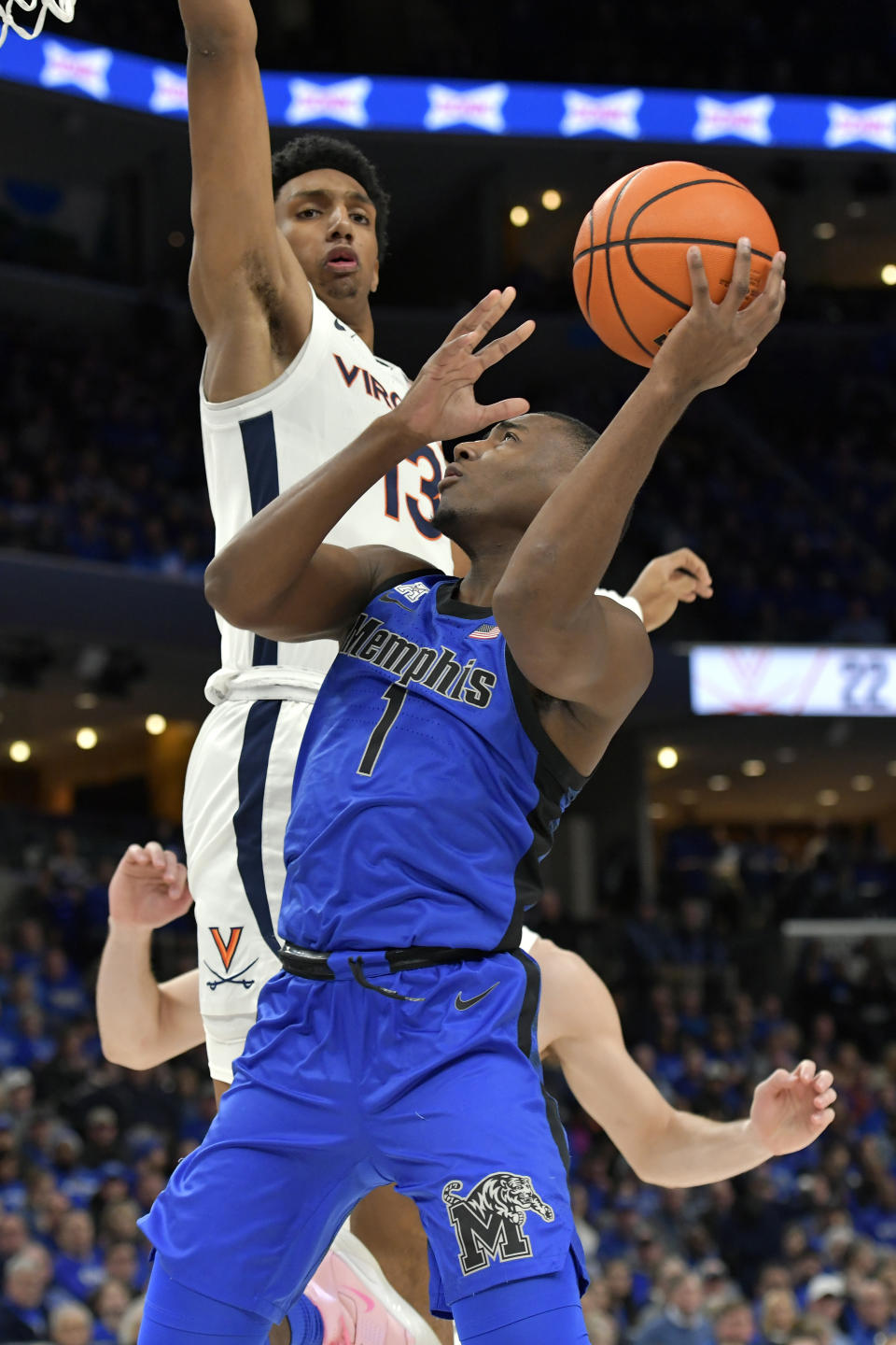 Memphis guard Jayhlon Young (1) shoots ahead of Virginia guard Ryan Dunn (13) during the first half of an NCAA college basketball game Tuesday, Dec. 19, 2023, in Memphis, Tenn. (AP Photo/Brandon Dill)