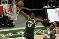 Milwaukee Bucks' Thanasis Antetokounmpo dunks during the second half of an NBA basketball game against the Sacramento Kings Sunday, Feb. 21, 2021, in Milwaukee. (AP Photo/Morry Gash)