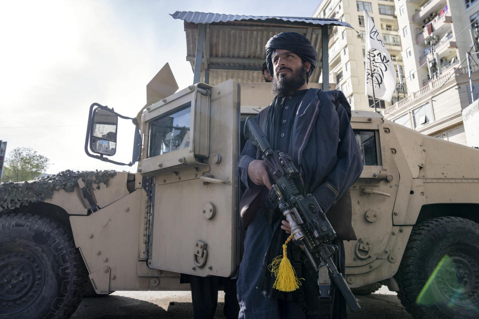 A Taliban fighter stands guard at the explosion site, near the Foreign Ministry in Kabul, Afghanistan, Monday, March 27, 2023. A suicide bomber has struck near the foreign ministry in the Afghan capital, killing at least six people and wounding about a dozen. (AP Photo/Ebrahim Noroozi)