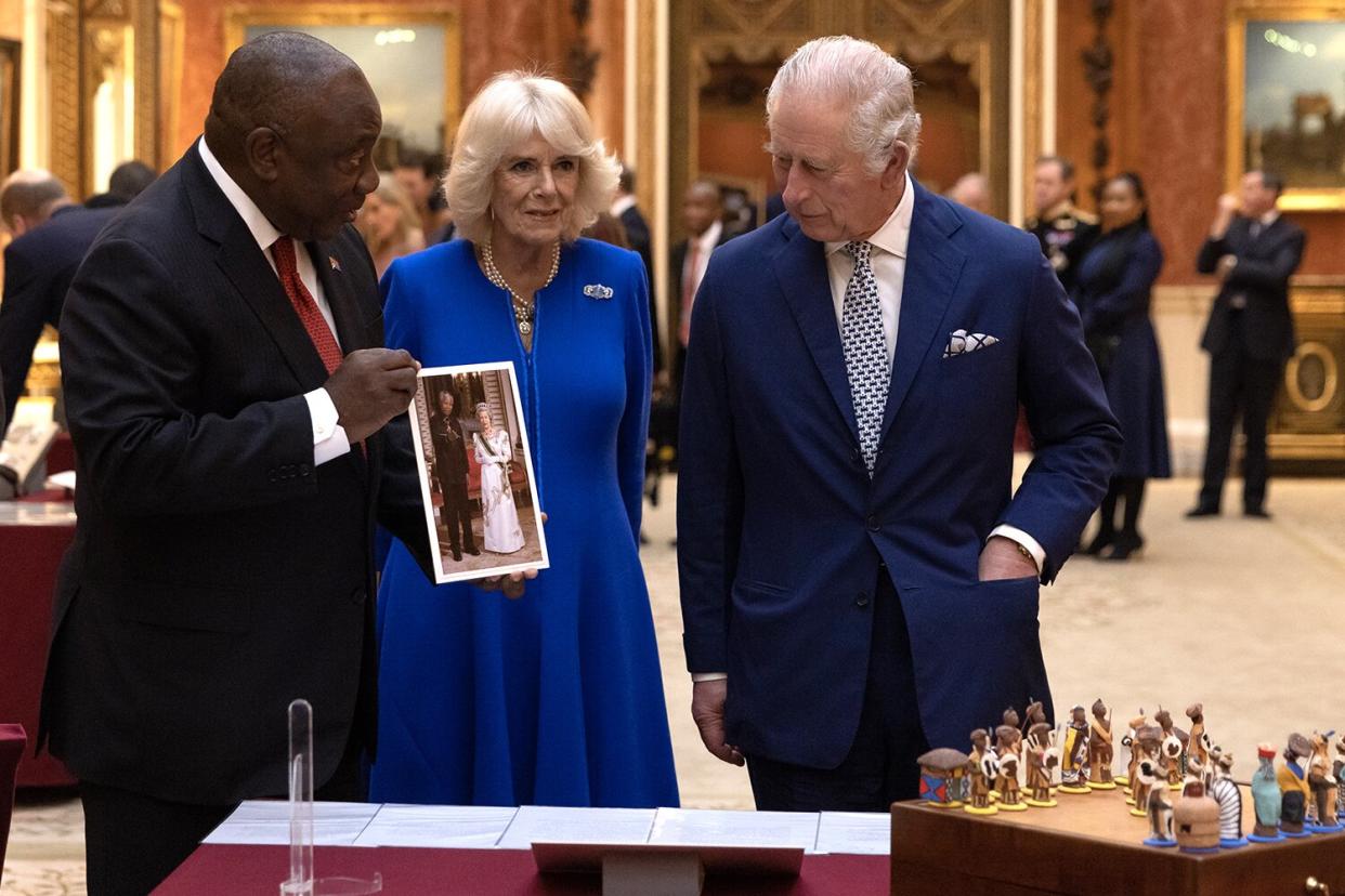 King Charles III and Camilla, Queen Consort show South African President Cyril Ramaphosa items, including a photograph of President Mandela and Queen Elizabeth II, displayed as part of the Royal Collection at Buckingham Palace