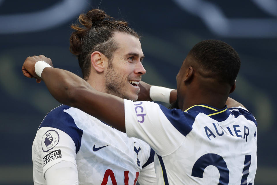 Tottenham's Gareth Bale, centre, celebrates with Tottenham's Serge Aurier after scoring his side's fourth goal during an English Premier League soccer match between Tottenham Hotspur and Burnley at the Tottenham Hotspur Stadium in London, England, Sunday, Feb. 28. 2021. (Matthew Childs/Pool via AP)