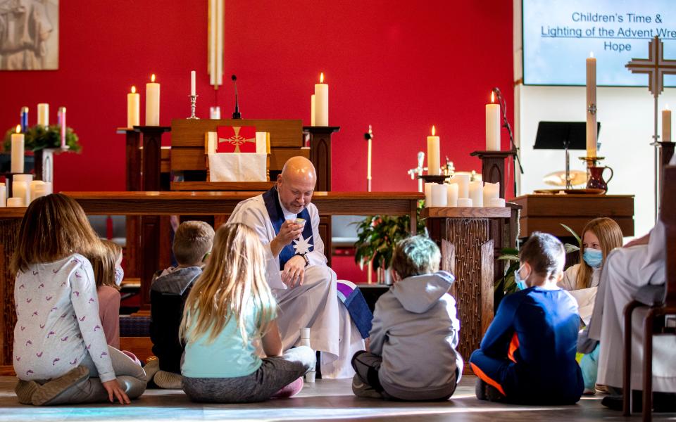 Lead Pastor Rev. Christian Marien leads an activity with kids Sunday on the importance of Advent and hope, especially during moments of tragedy, Sunday at Ascension Lutheran Church in Waukesha.