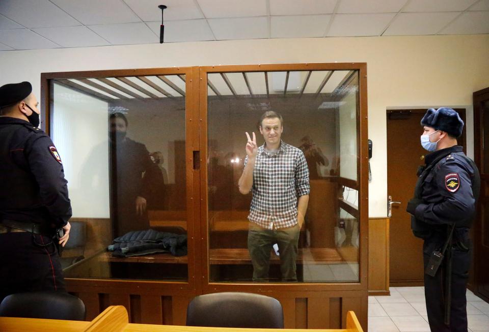 Russia opposition leader Alexey Navalny stands in a cage in court in Moscow in February.