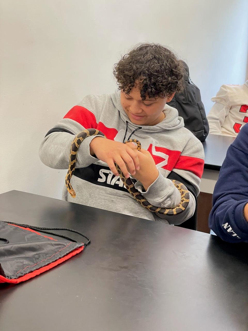 Port Clinton High School student, Jerren-Lee Hirt holds a fox snake, during his Science class field trip to Ohio State University Stone Lab on Gibraltar Island.