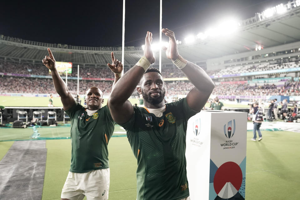 South Africa's Siya Kolisi, center, and Bongi Mbonambi celebrate after defeating Japan in the Rugby World Cup quarterfinal match in Tokyo, Sunday, Oct. 20, 2019. (AP Photo/Jae C. Hong)