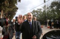 Algeria's presidential candidate Abdelmadjid Tebboune greets attendees during the presidential election in Algiers