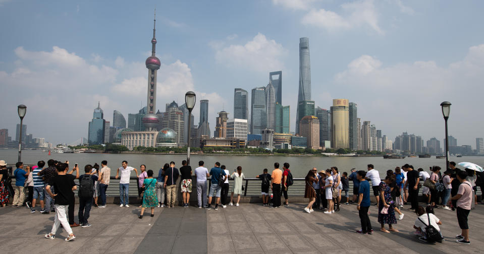 08 September 2019, China, Shanghai: Tourists stand at the promenade "The Bund" at the Huangpu river with a view of the skyline of the special economic zone Pudong with its skyscrapers. On the left you can see the Oriental Pearl Tower and on the right the Shanghai Tower. Photo: Swen Pförtner/dpa (Photo by Swen Pförtner/picture alliance via Getty Images)